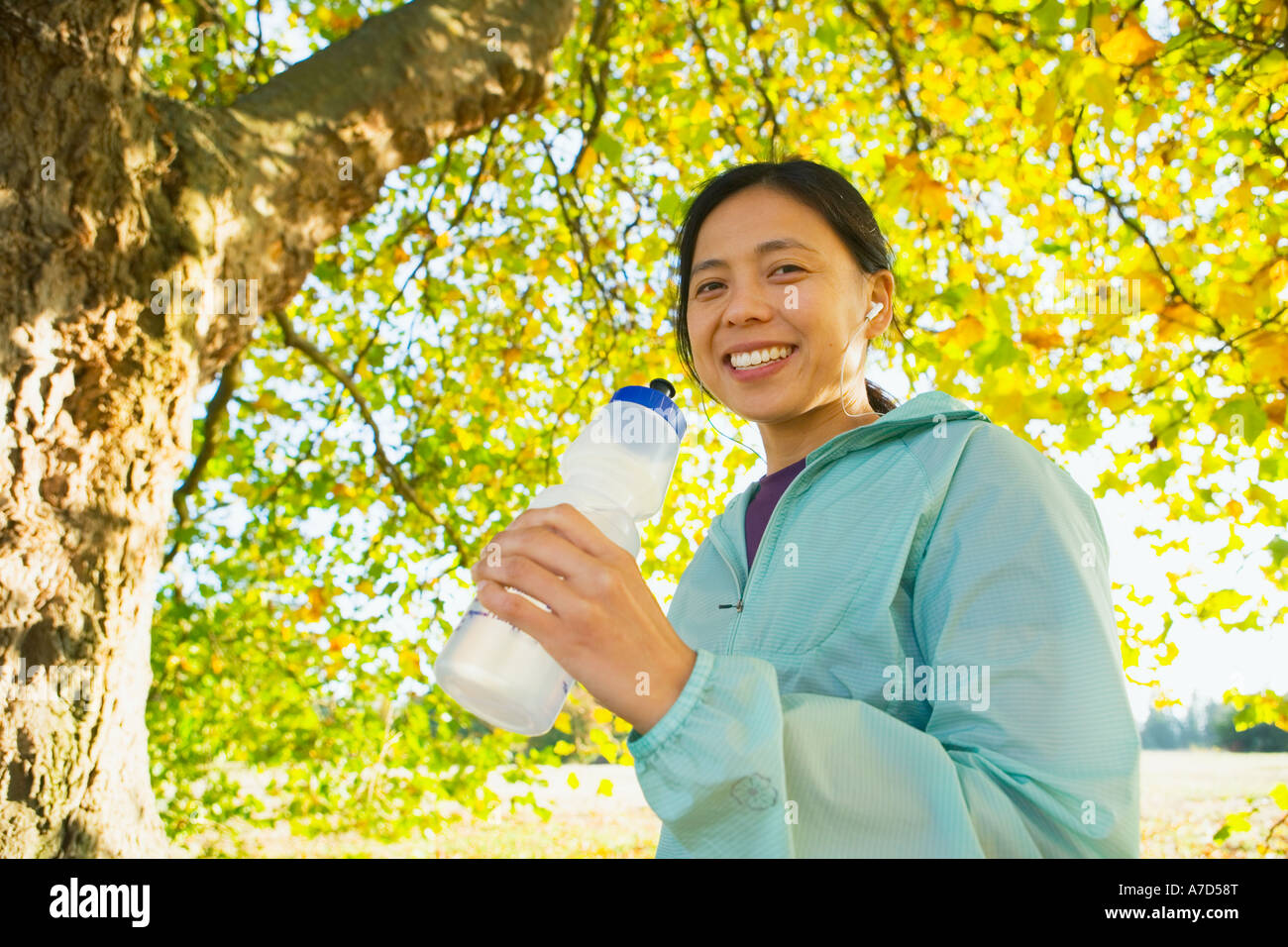 Young female with water bottle and MP3 player Stock Photo Alamy