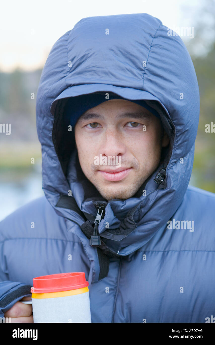Young man of mixed ethnicity in hooded jacket Stock Photo