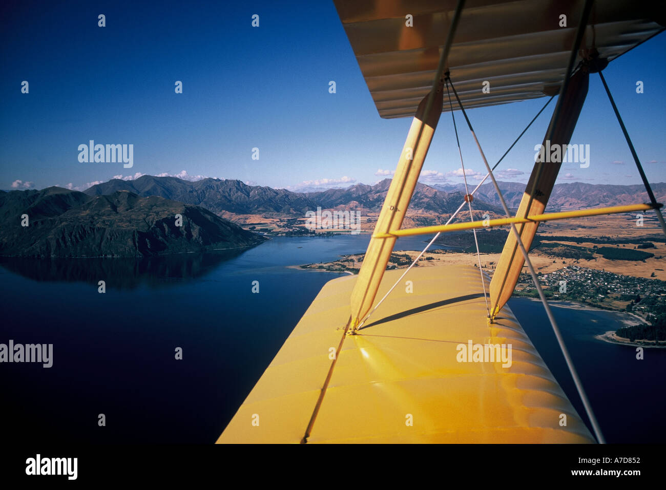 Tiger Moth Biplane over Lake Wanaka New Zealand aerial Stock Photo