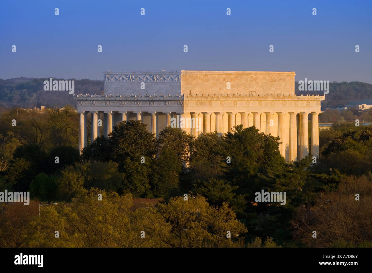 Washington DC is a green city. The Lincoln Memorial amidst evergreen trees. North west facade at sunset. Stock Photo