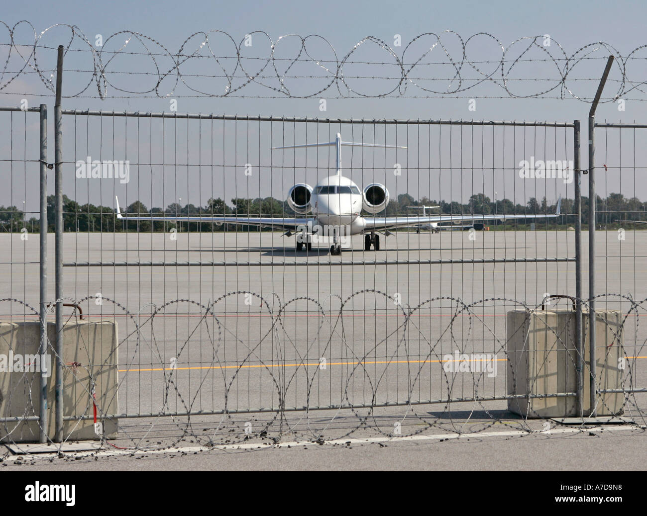 Privat jet behind a security fence at general aviation area at Munich Airport Bavaria Germany Stock Photo