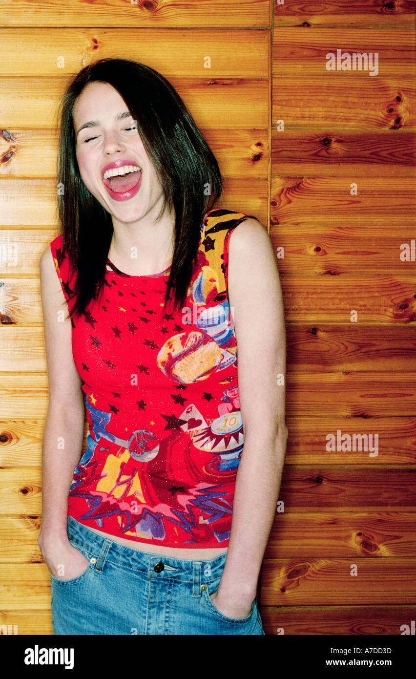 EXUBERANT TEENAGER WITH HANDS IN JEANS Stock Photo