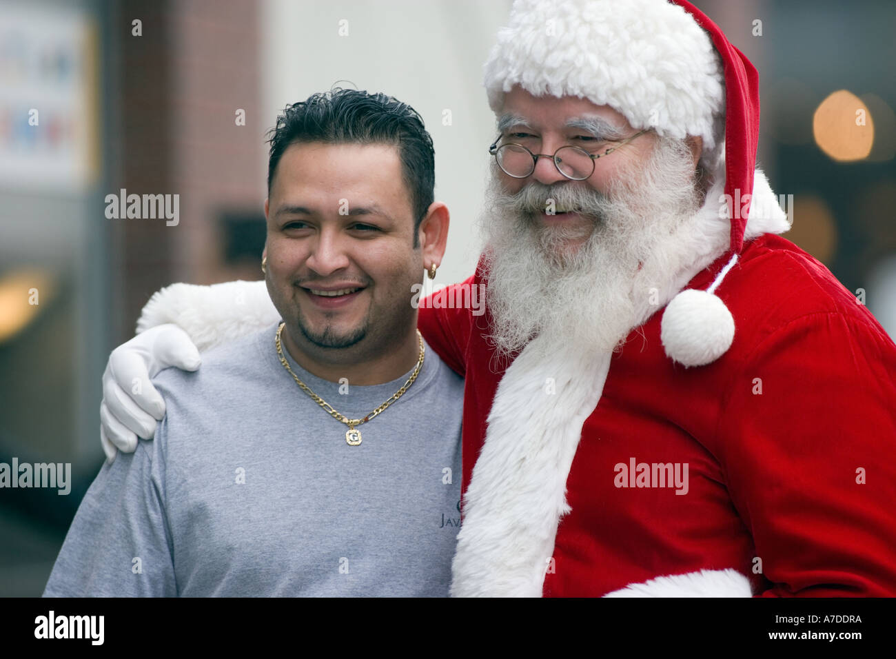 Latino man posing with Santa Claus Stock Photo - Alamy