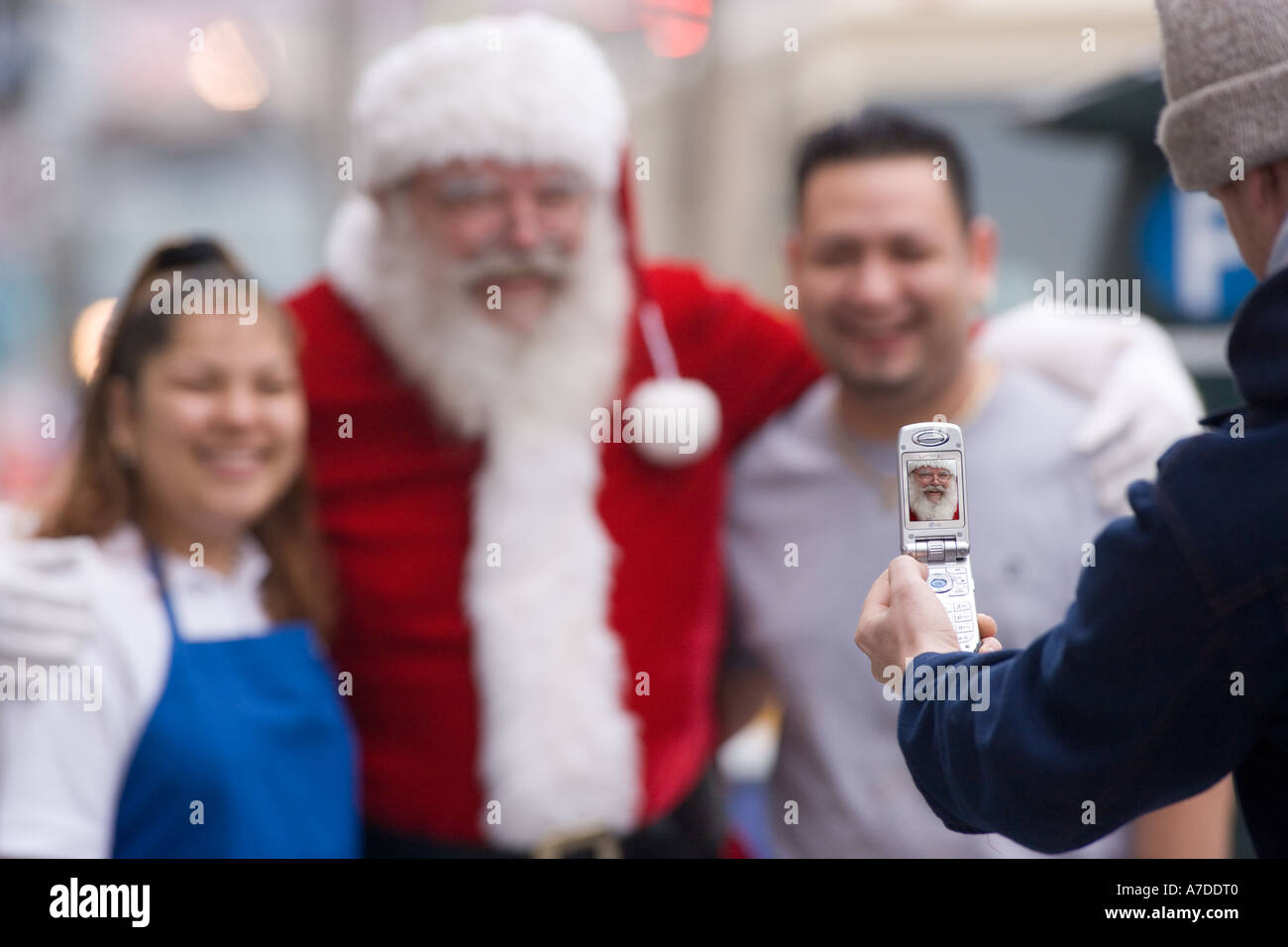 Latino couple posing with Santa Claus Stock Photo