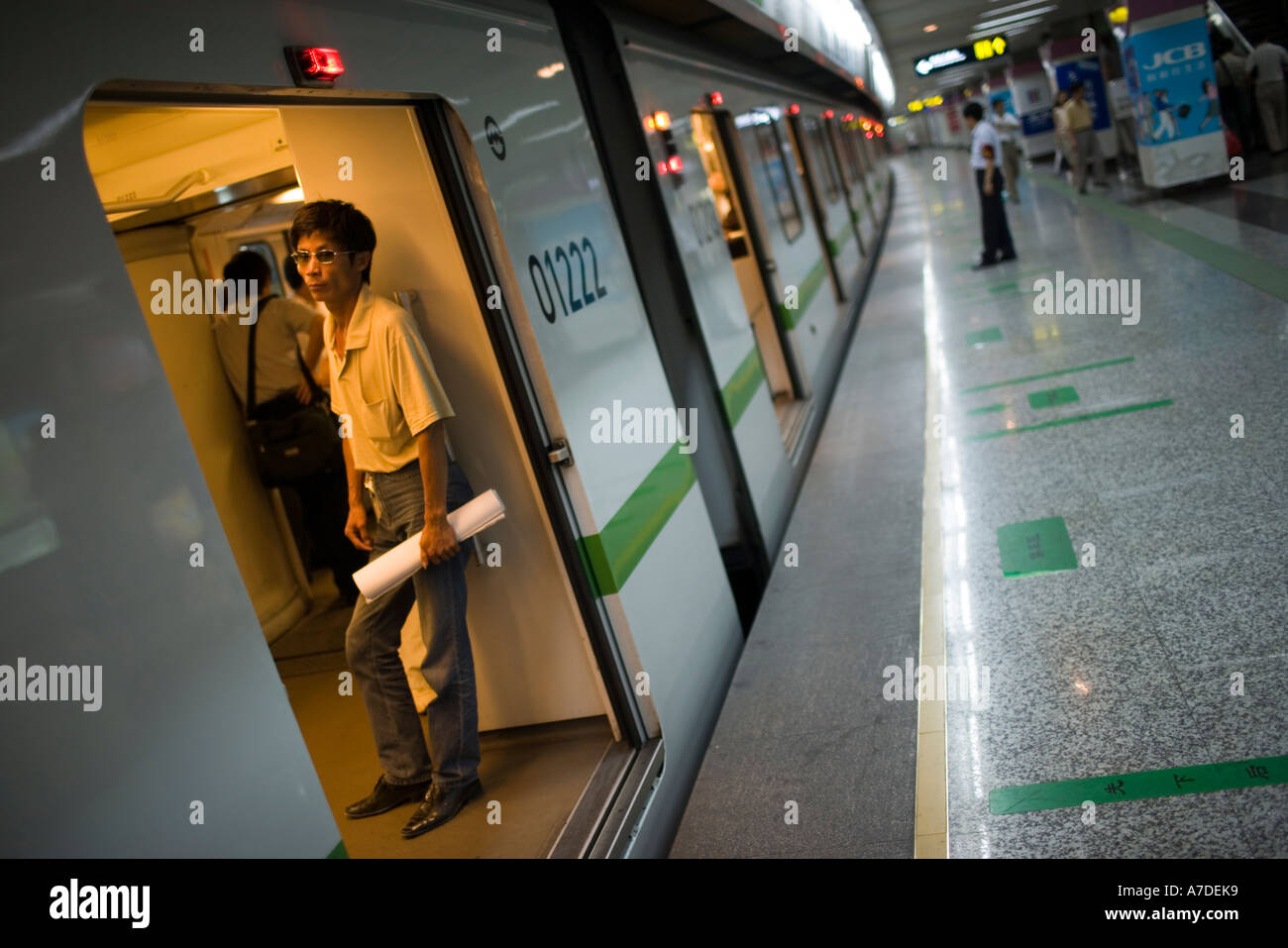 MAN WITH MEGAPHONE PUSH COMMUTERS INTO CROWDED TRAIN SO DOORS WILL CLOSE  RUSH HOUR AT PEOPLE S SQUARE SHANGHAI CHINA Stock Photo - Alamy