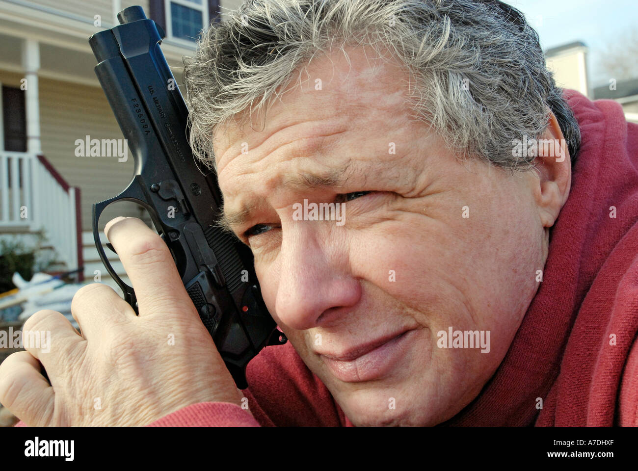 Adult dangerous man holding a hand gun Stock Photo