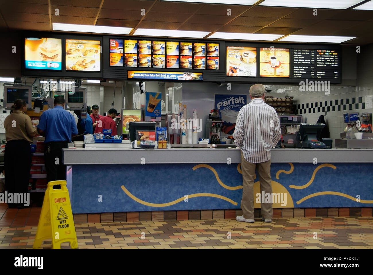 patrons at mcdonald s fast food restaurant stand in line to place an order for food stock photo alamy
