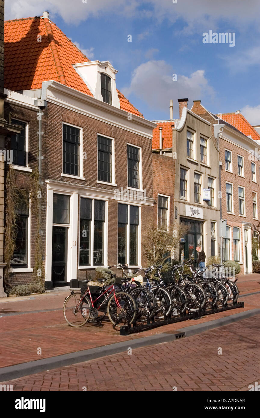 Row of parking bicycles with typical Dutch apartment buildings in background Haarlem North
