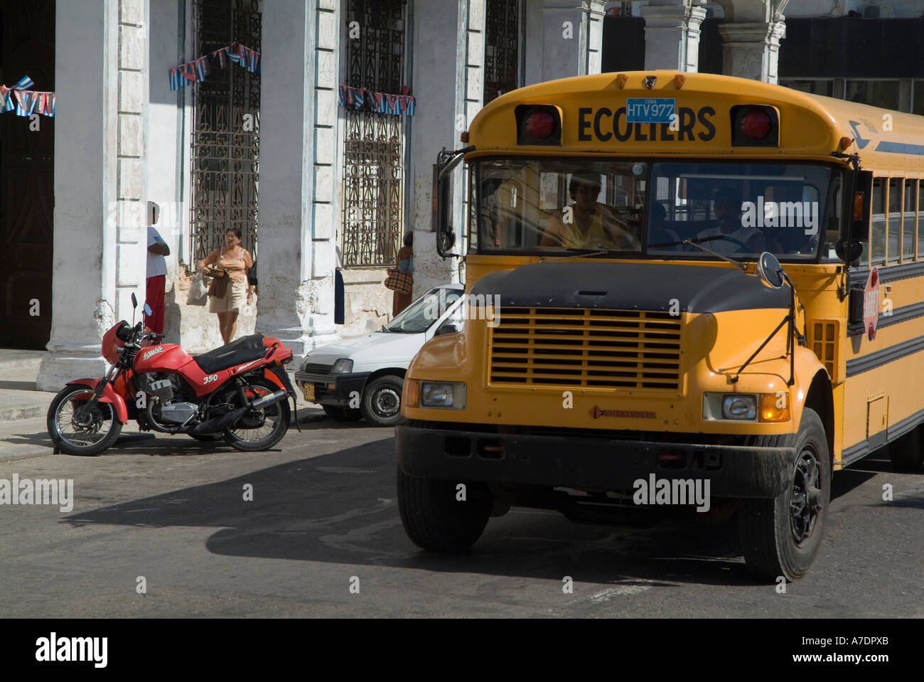 Yellow French school bus driving on Prado avenue in Havana streets Cuba Stock Photo