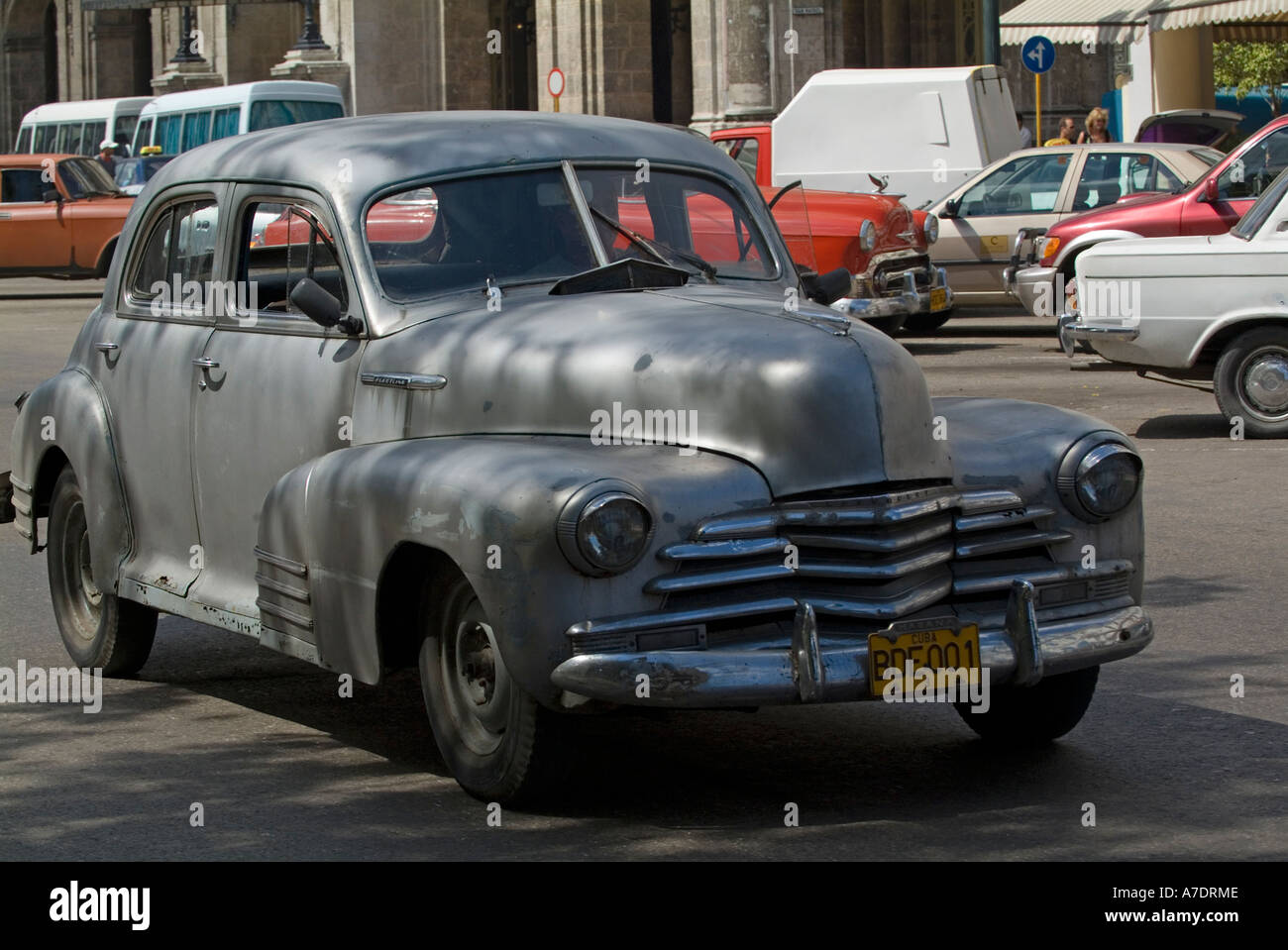 Old Classic American grey car driving in Havana Cuba Stock Photo
