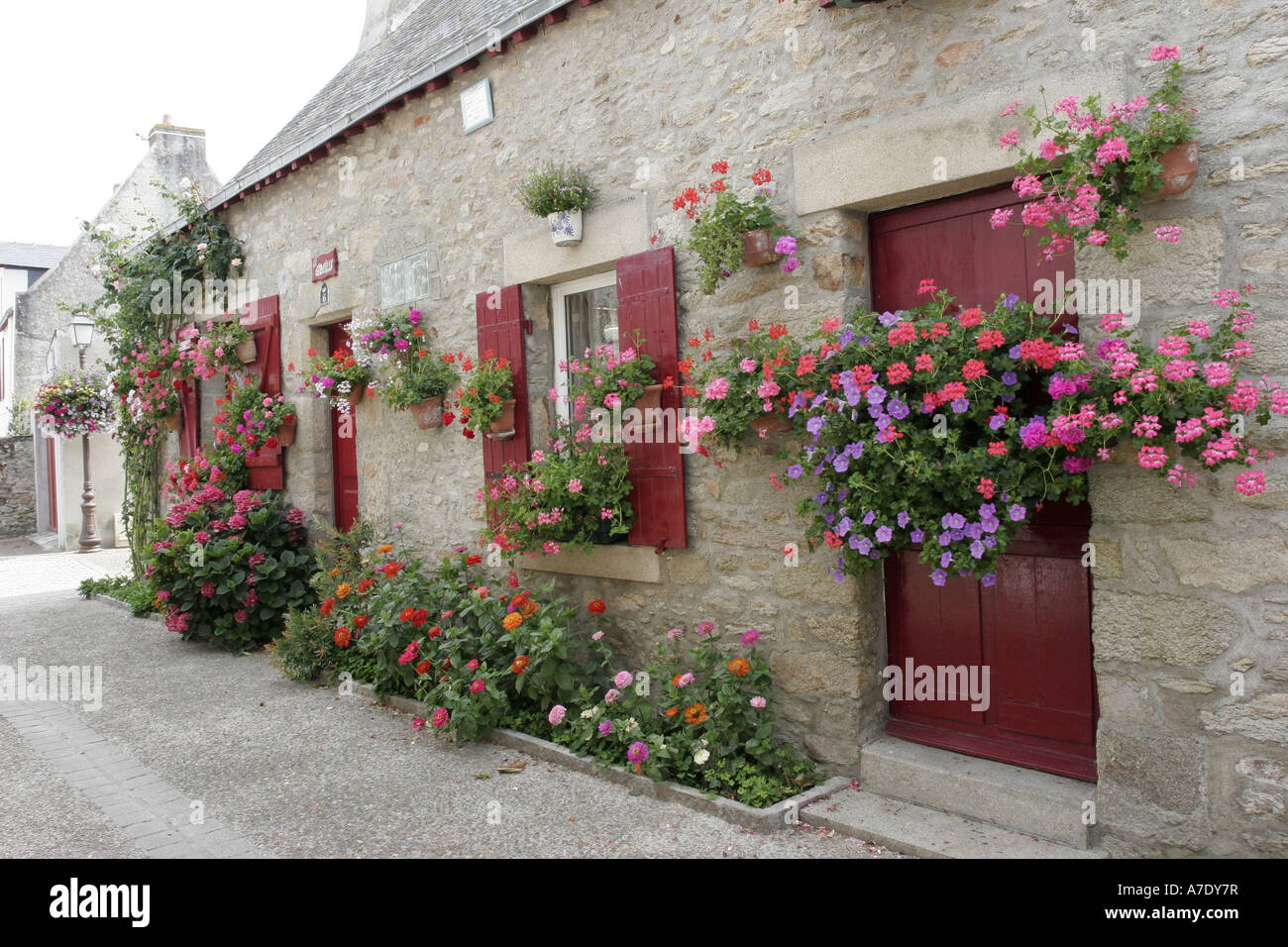 building with red window shutter and flowers, France, Brittany, Loire Atlantique, Piriac Stock Photo