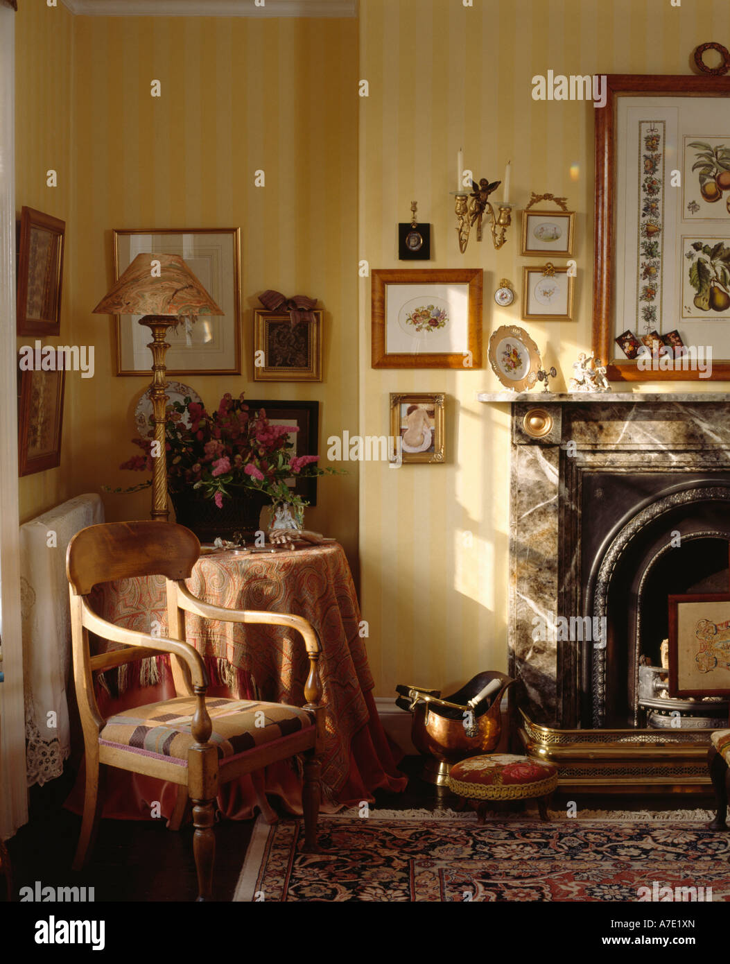 Antique wooden chair in sittingroom with yellow striped wallpaper and