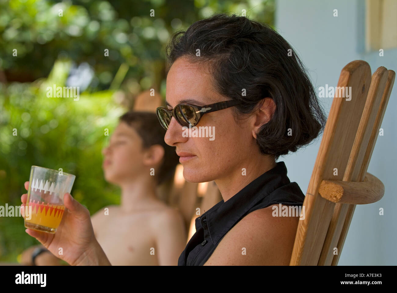 Mother and son having a drink on a terrace after hiking, Vinales, Pinar del Rio Province, Cuba. Stock Photo