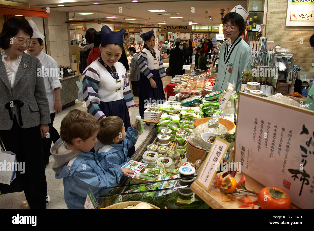 Shops and stalls with two western boys people and shoppers in Tokyo Station basement city of Tokyo Japan Asia NAOH CJWH Stock Photo