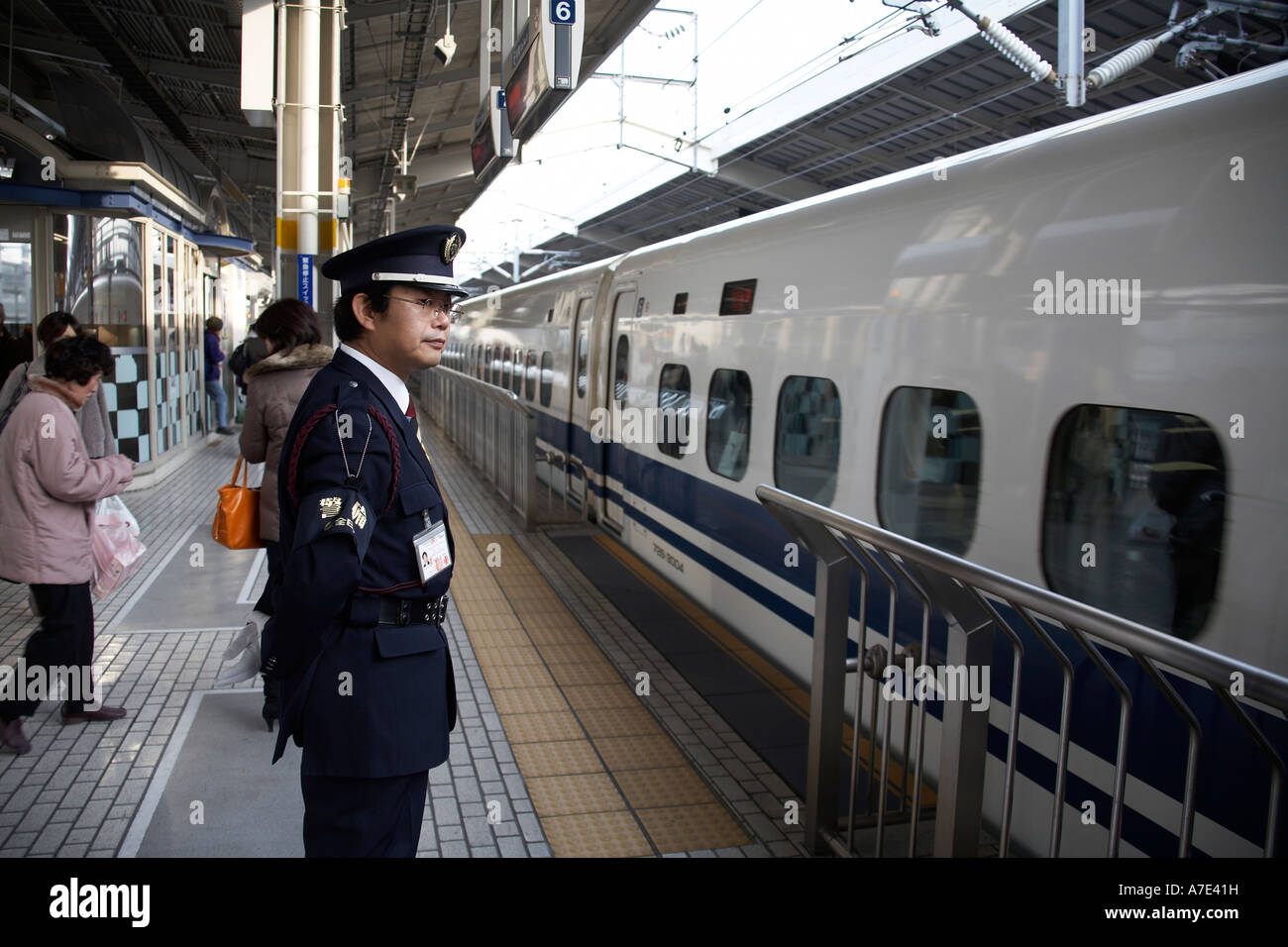 Japan Railways Shinkansen Super express Bullet train and platform guard in Kyoto railway station Japan Asia Stock Photo