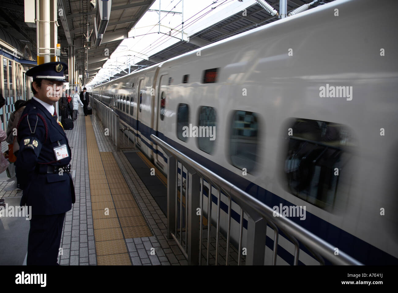 Japan Railways Shinkansen Super express Bullet train moving and platform guard in Kyoto railway station Japan Asia Stock Photo