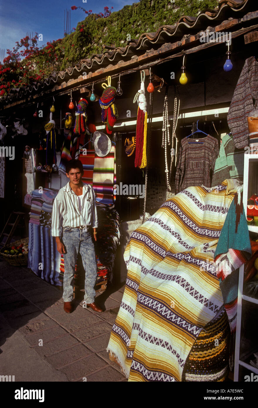 Mexican man vendor selling blankets rugs handicrafts Plaza