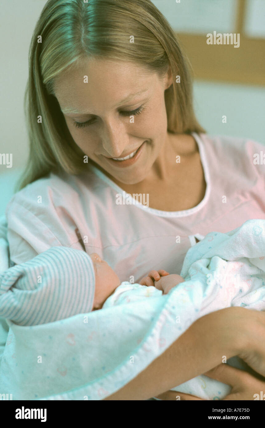 Mother holding newborn in hospital room Stock Photo - Alamy