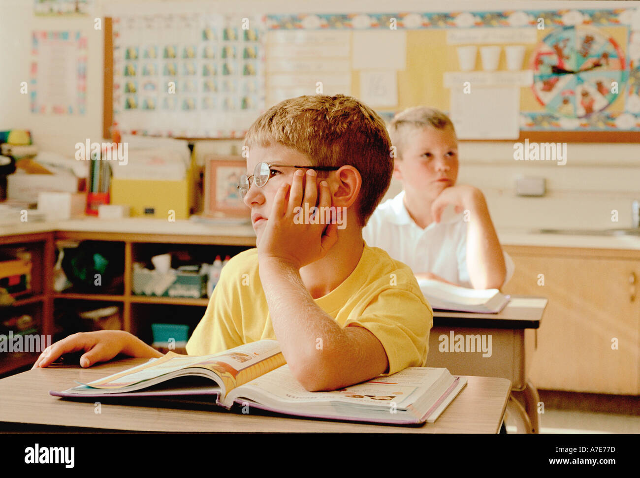 Schoolboy daydreaming in class Stock Photo