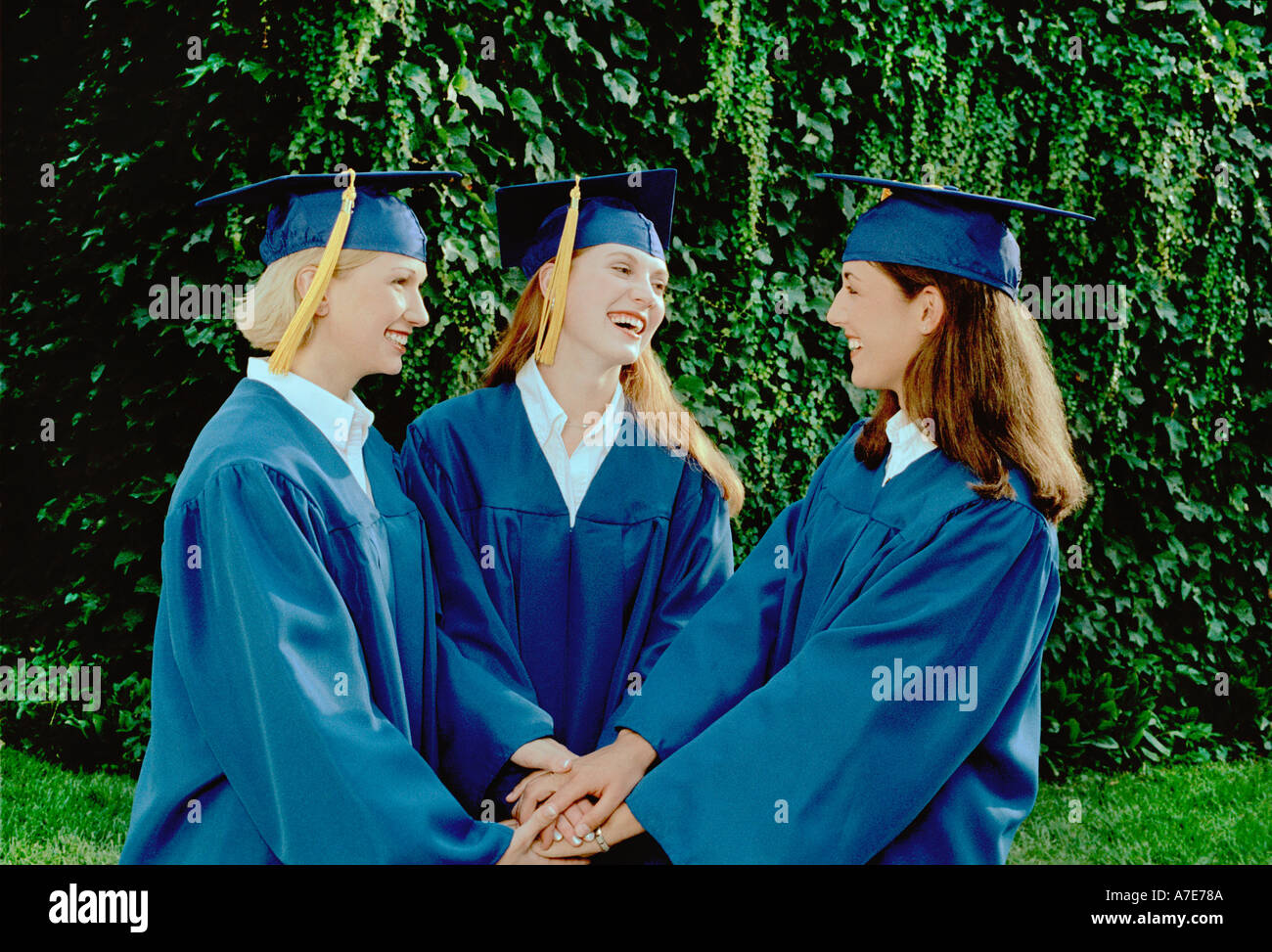 Three female graduates congratulating each other Stock Photo - Alamy