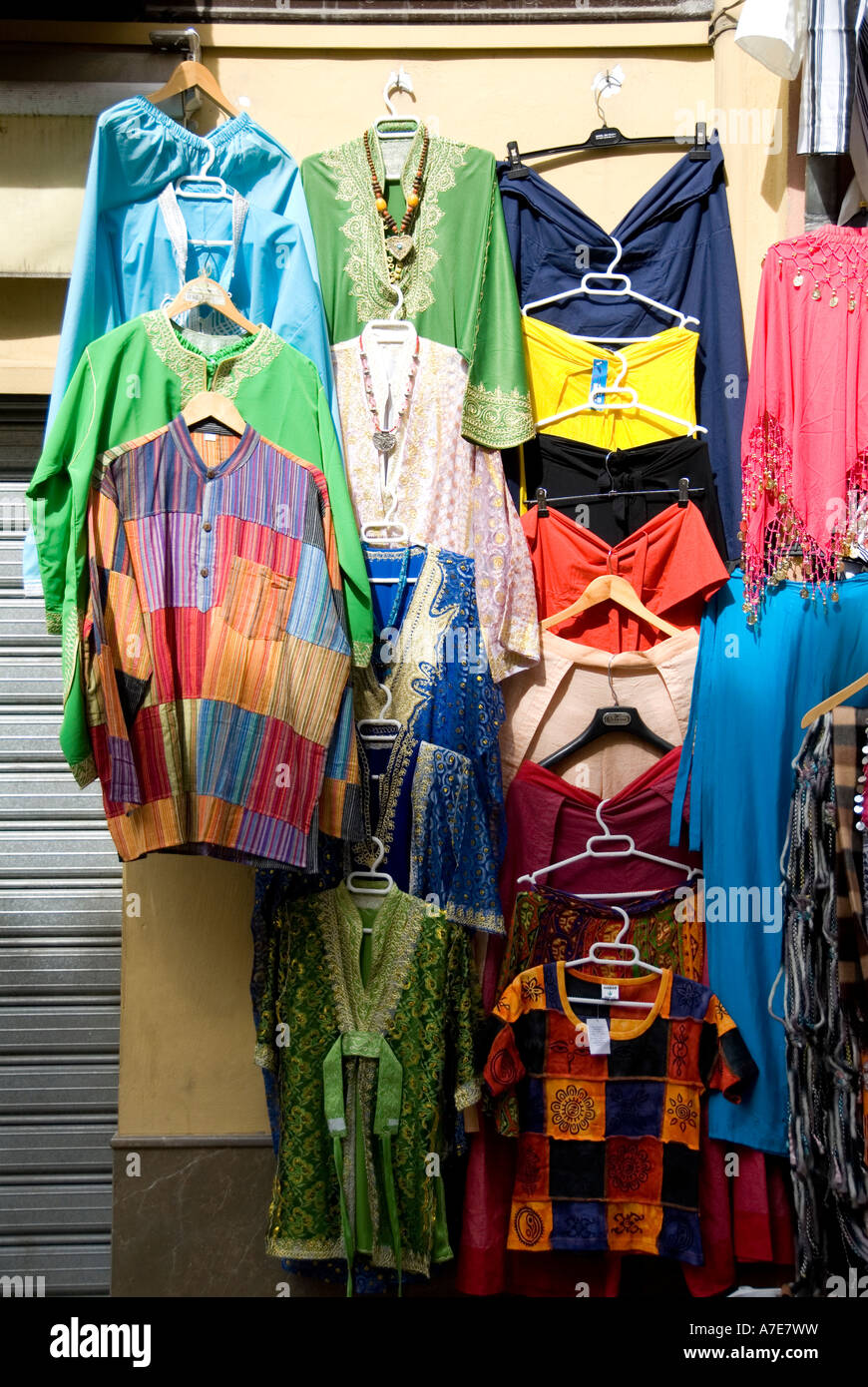 Display of colourful dresses and clothes in a shop of Granada Spain