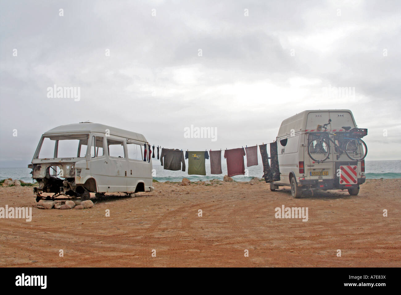 Camping life drying washing on a trist and cloudy day on the shore of Salema Bay Algarve Portugal Europe Stock Photo