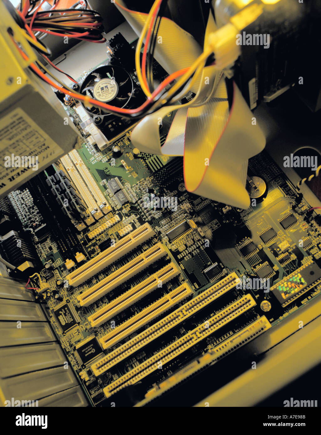 Inside a personal computer, showing mother board with SCSI connections for outlet ports at the base of the picture. Stock Photo