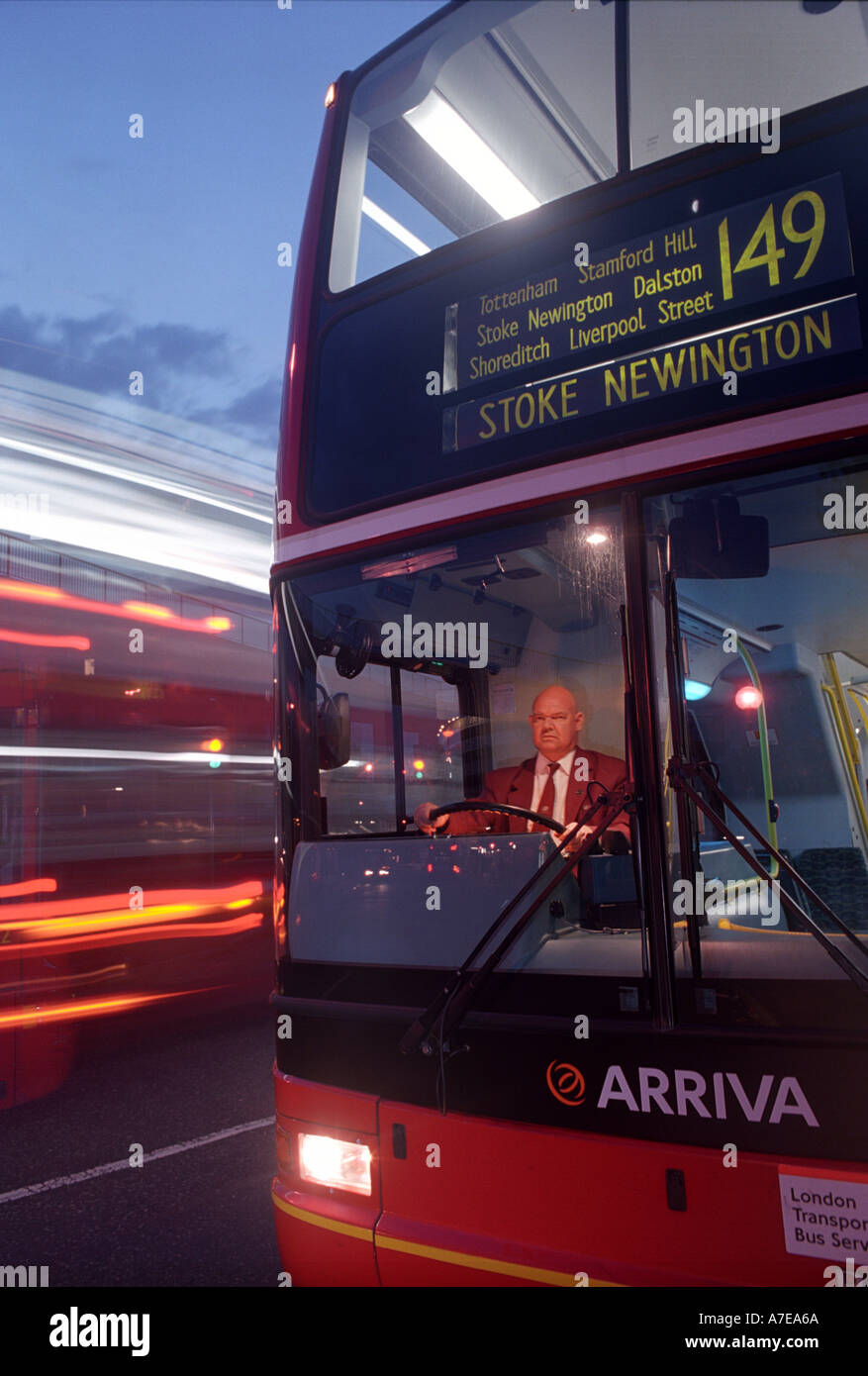 A bus driver prepares to pull out into the road whilst buses pass him