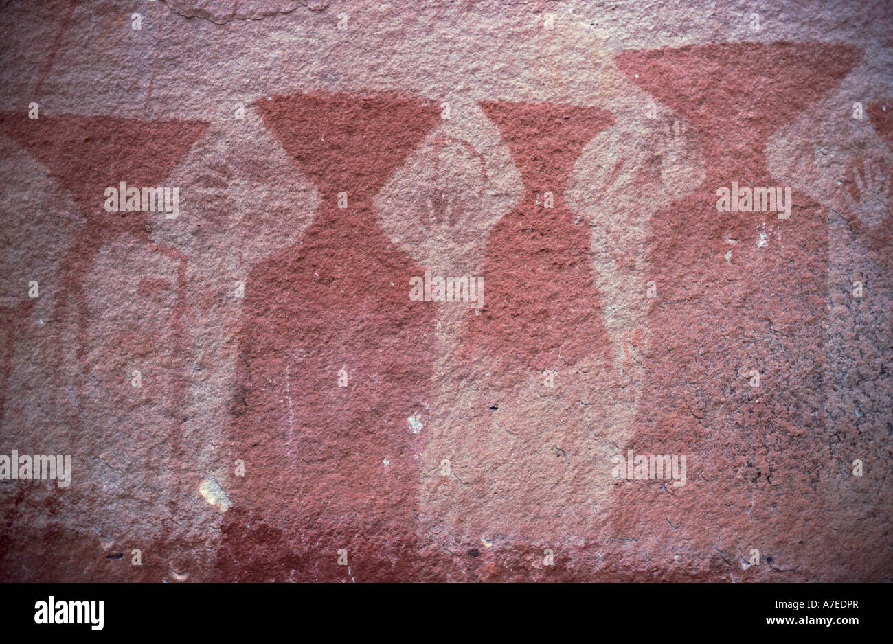 Cliff paintings featuring alien looking triangular headed people and spray human hand prints, Pha Taem Historical Park, Thailand Stock Photo