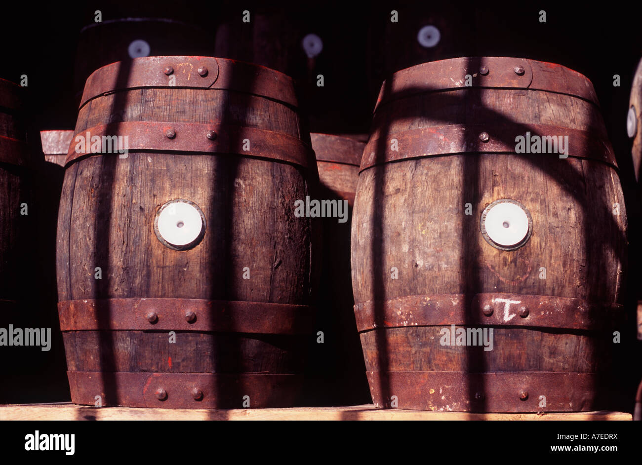 Two oak kiln casks stored behind iron gates of Wadworth brewery