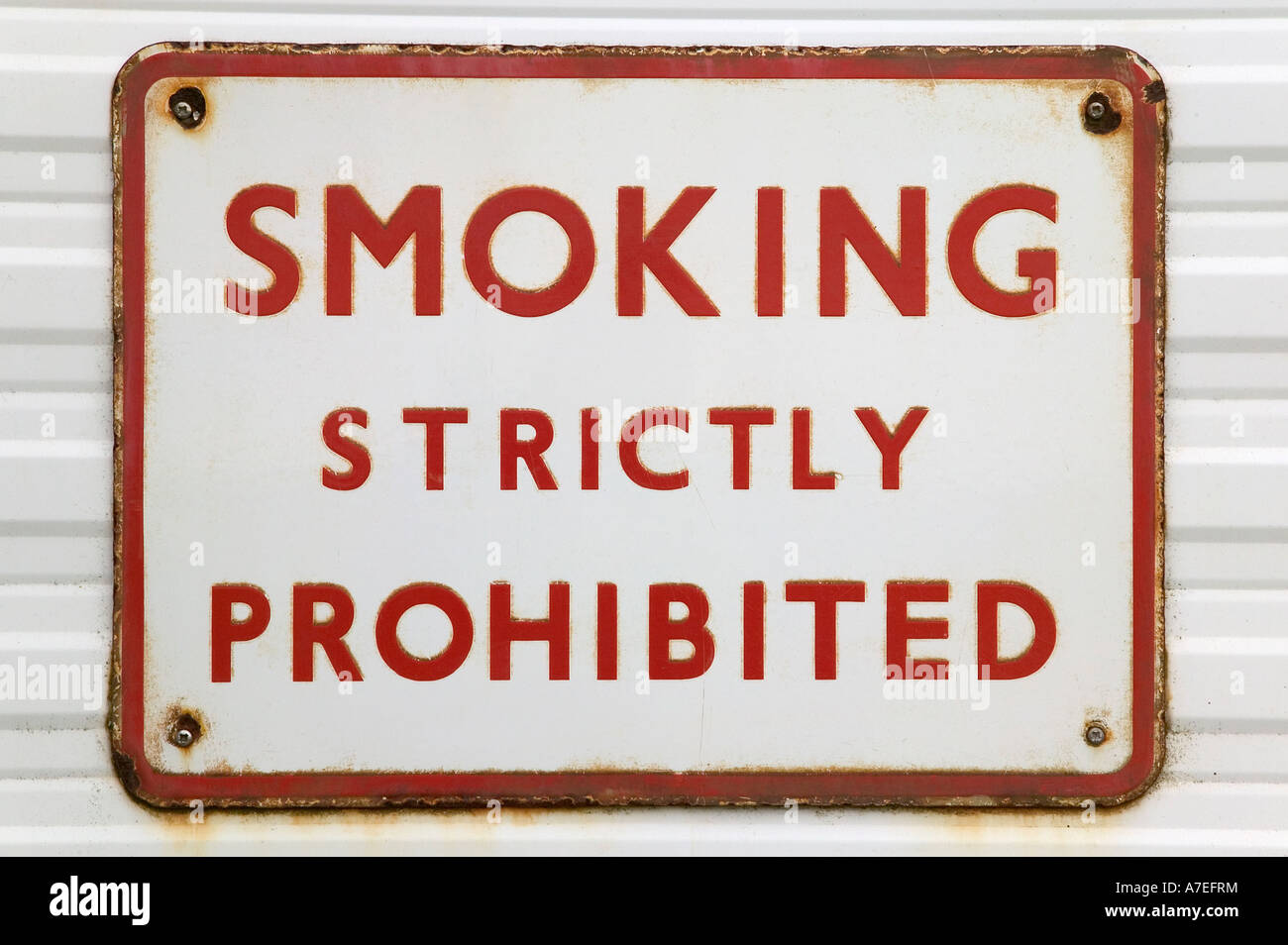 Rusted old sign with text Smoking strictly prohibited Stock Photo