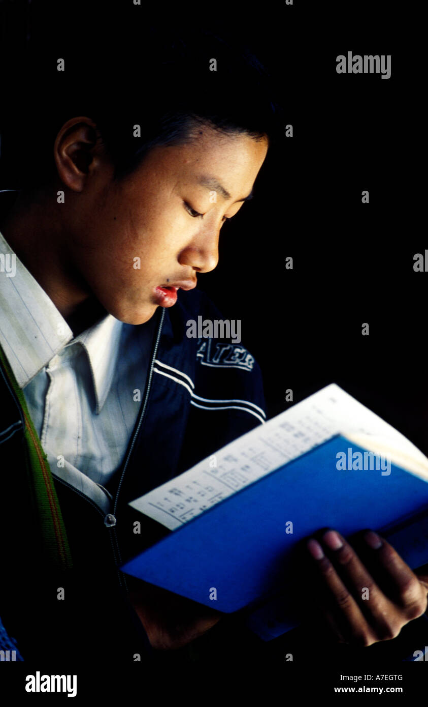 Young Asian boy holding a hymn book Stock Photo