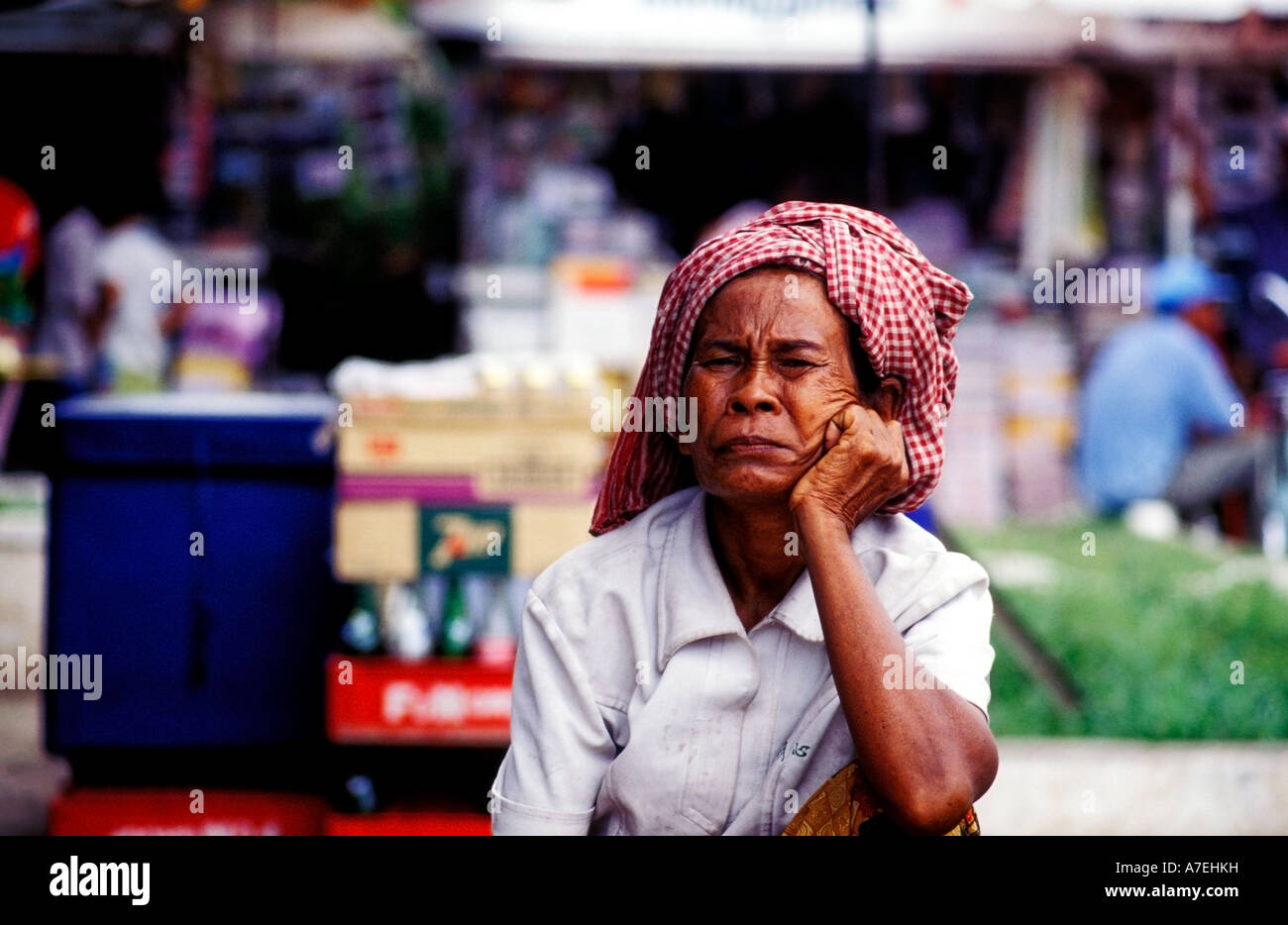 Vendor wearing a traditional krama head scarf outside Psah Thmay central market in Phenom Penh Stock Photo