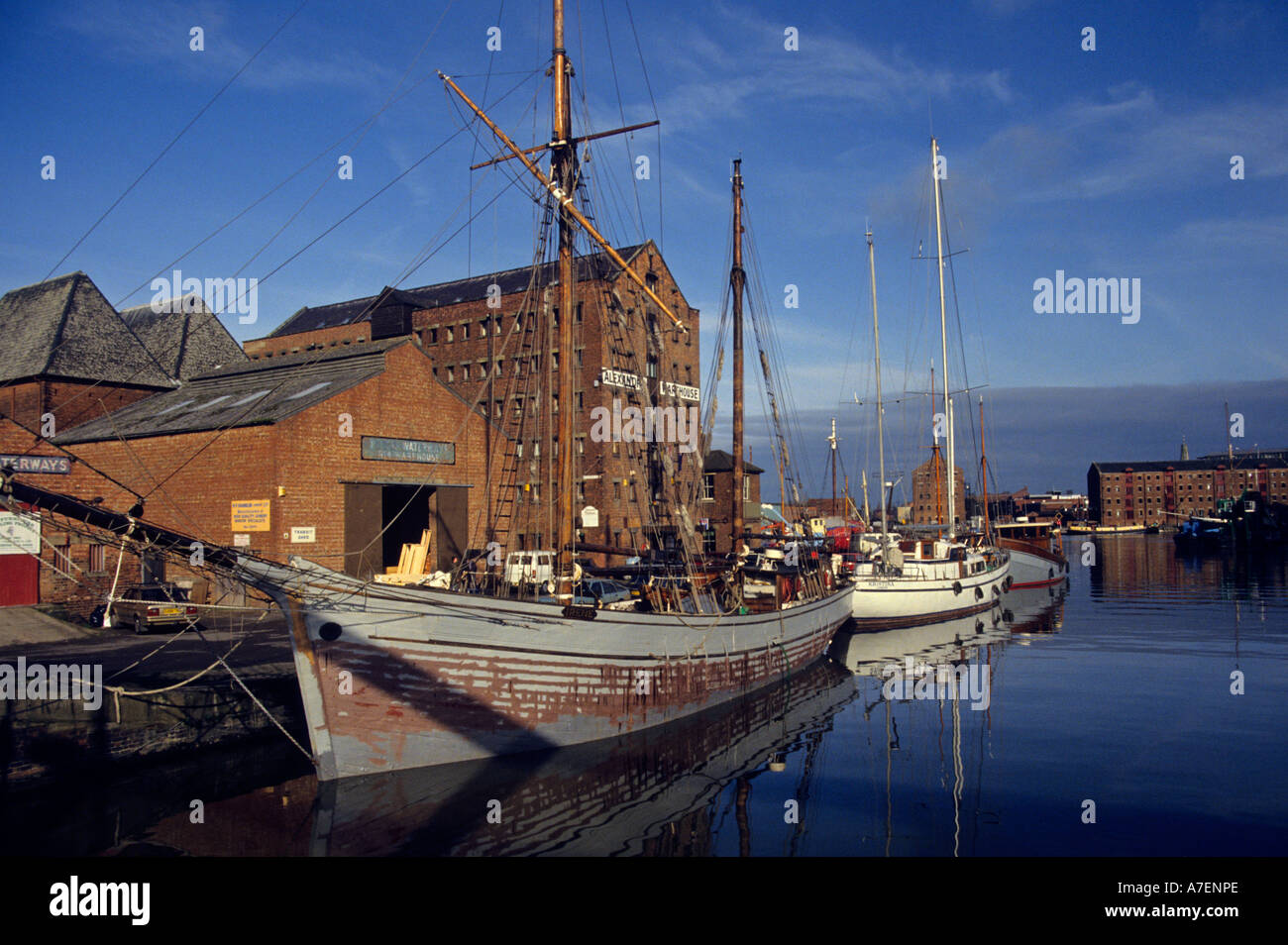 Warehouses and traditional boats Gloucester docks Gloucester England UK Stock Photo