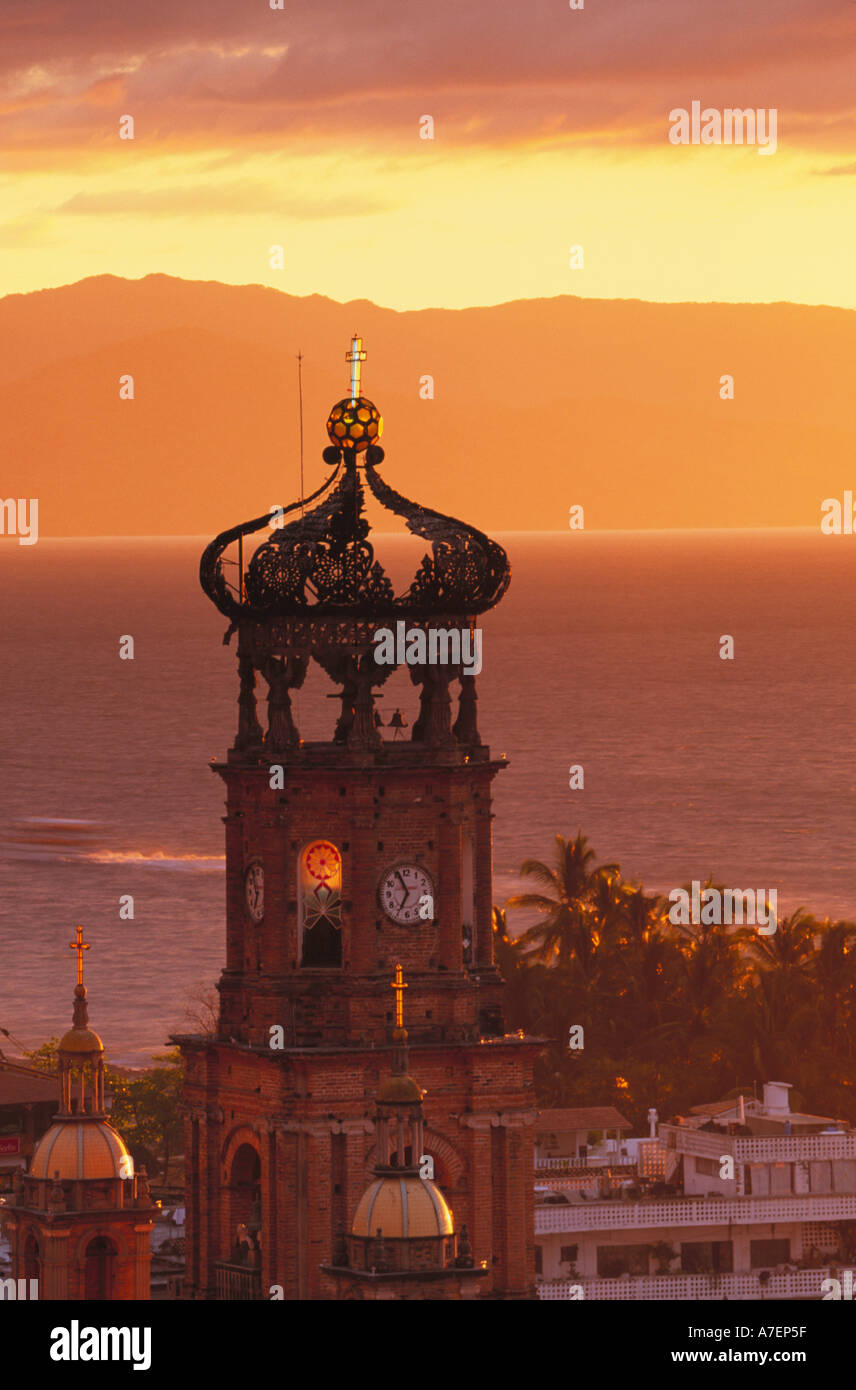 Mexico, Jalisco, Puerto Vallarta. Church tower at sunset (Nuestra Senora de Guadalupe, built 1902) and Bay of Banderas. Stock Photo