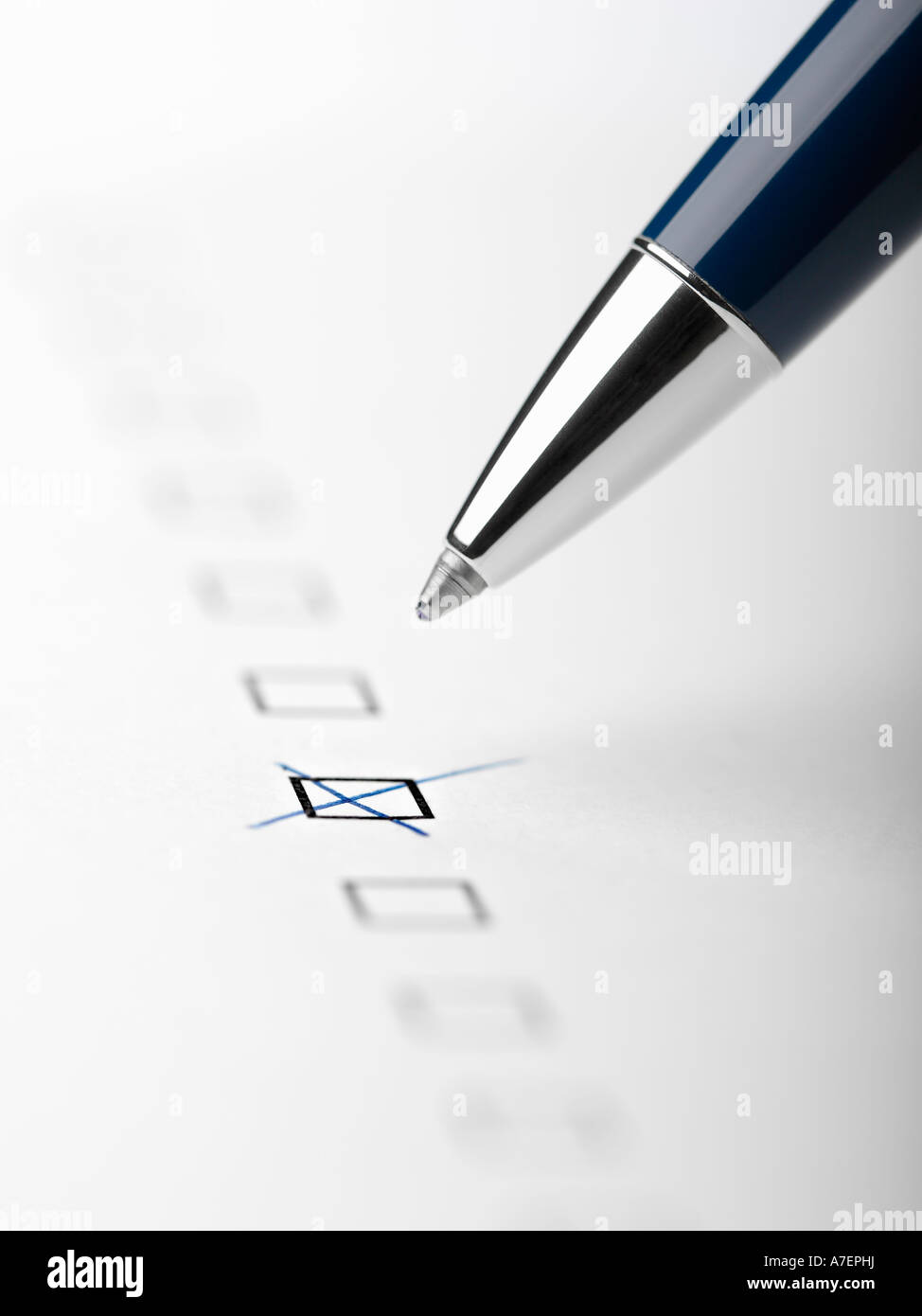 Pen writing X in checkbox close up crop Stock Photo