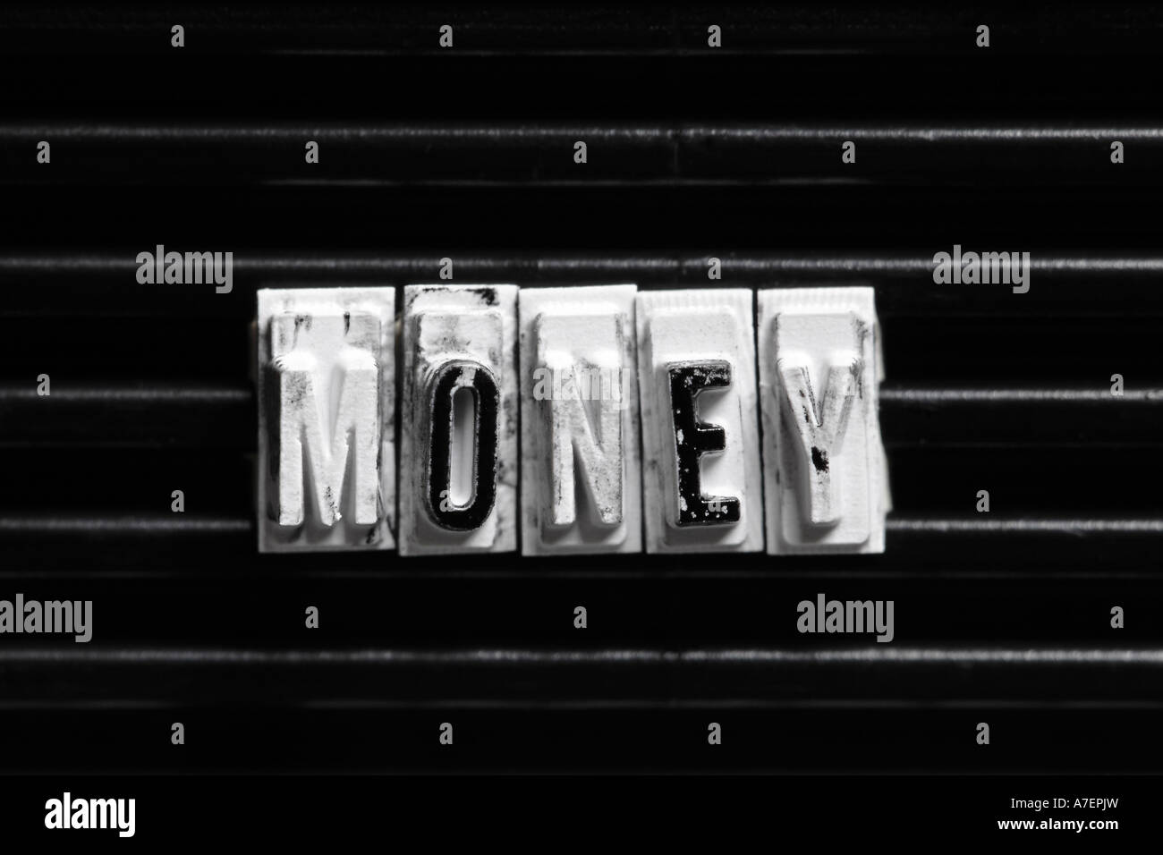 Dirty rubber type spelling MONEY, close up, money laundering Stock Photo