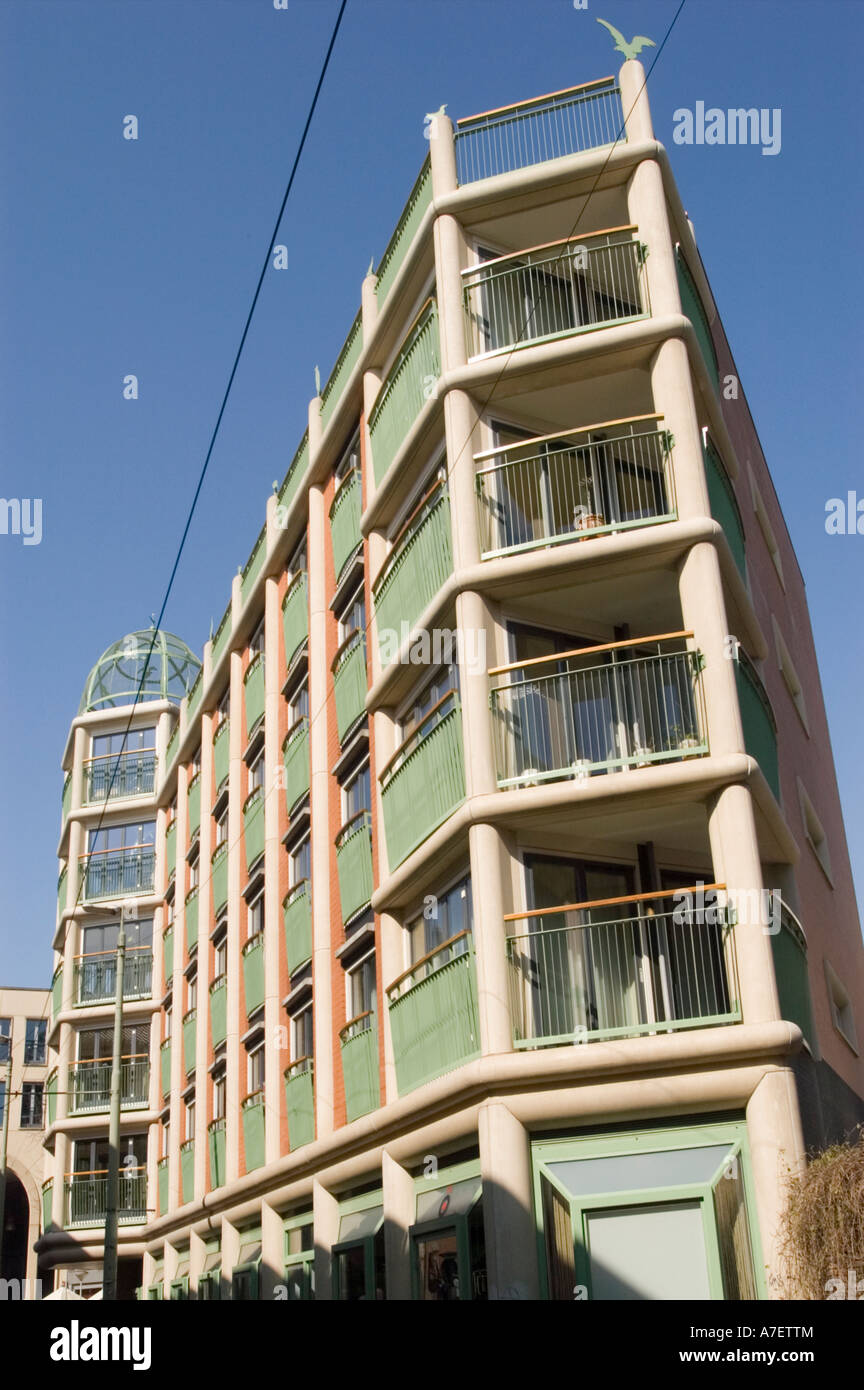 Modern apartment house with green balcony and tram wires in Den Haag