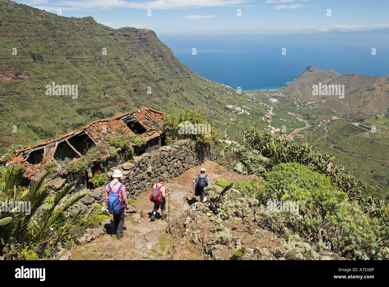 Hiker passing a tumbledown house in the valley of Hermigua, La Gomera Island, Canary Islands, Spain, Europe Stock Photo