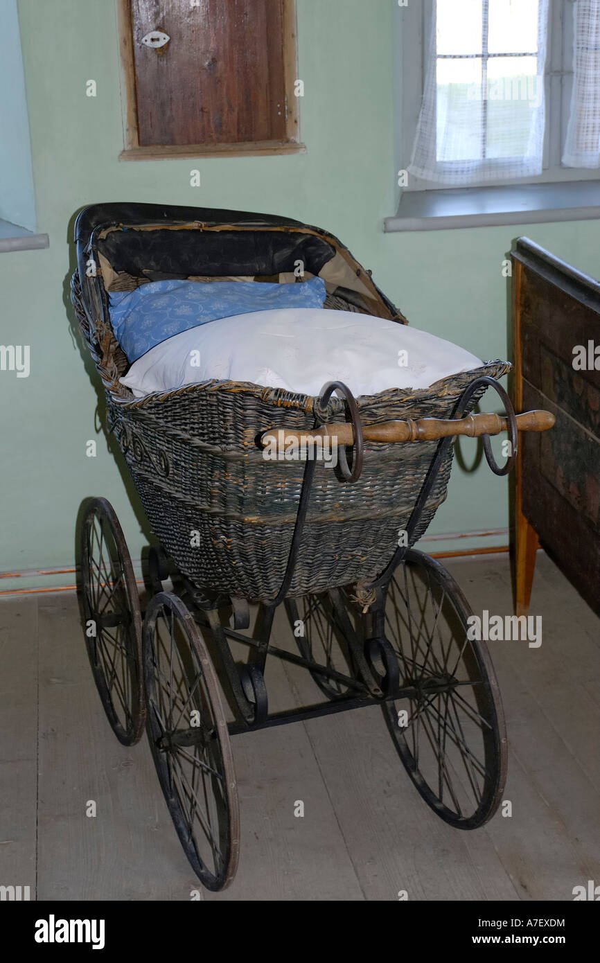 Old baby carriage displayed in the farmhouse museum of Amerang, Bavaria, Germany Stock Photo