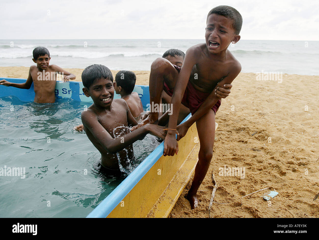 Children who have survived the Tsunami are getting familiar with the water in small pools near the ocean.Colombo, Sri Lanka Stock Photo