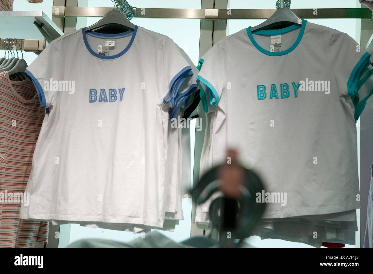 Baby tshirts on display on a rack at Destination Maternity store in New York City USA March 2006 EDITORIAL USE ONLY Stock Photo