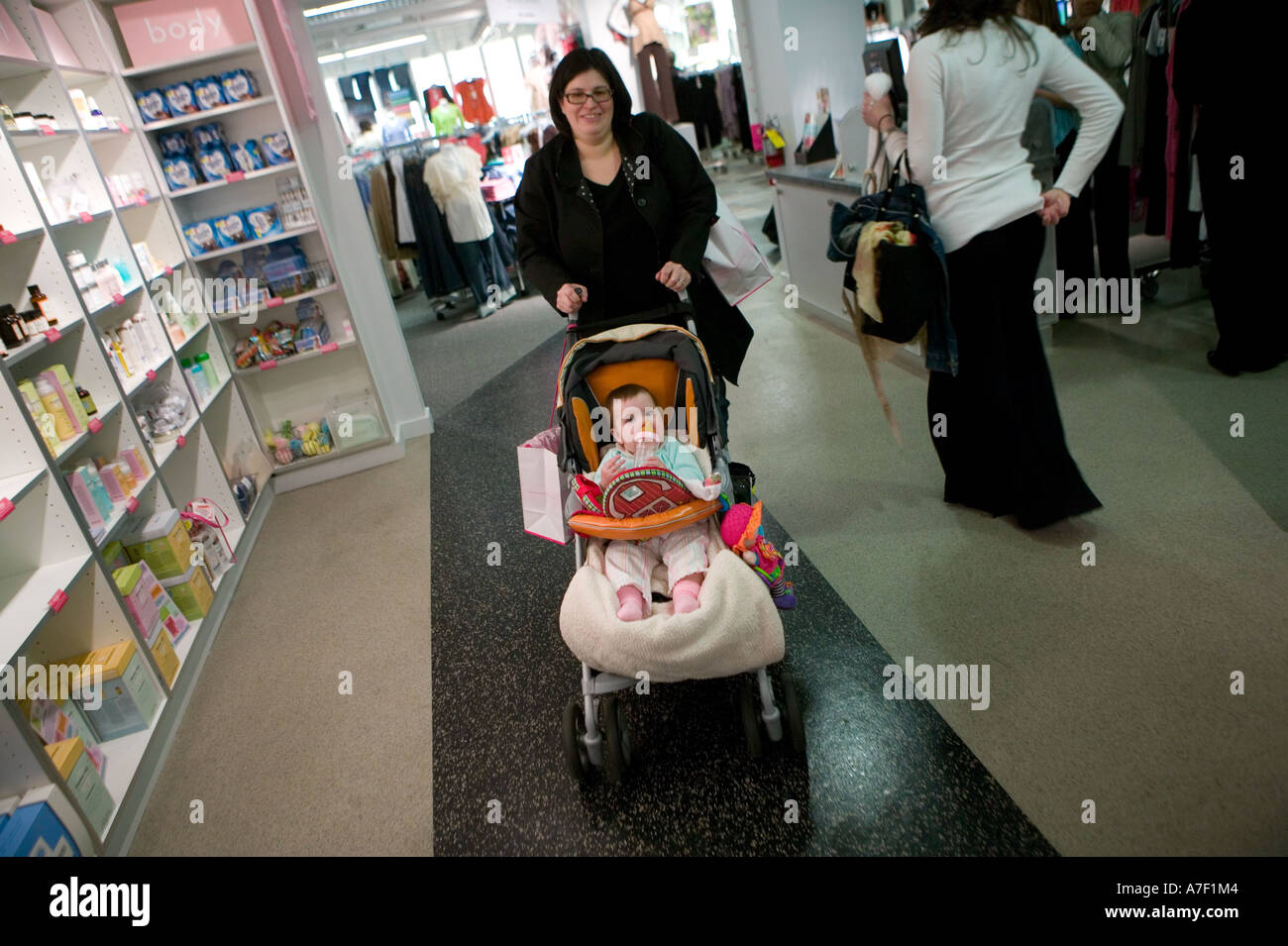 Woman shoping with baby for clothes at the Destination Maternity store New York City USA March 2006 EDITORIAL USE ONLY Stock Photo