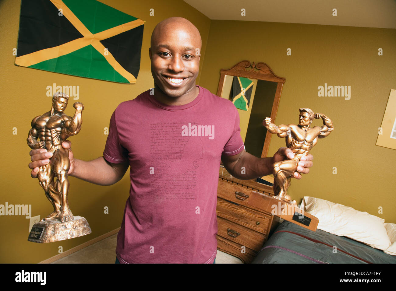 African man holding body building trophies Stock Photo