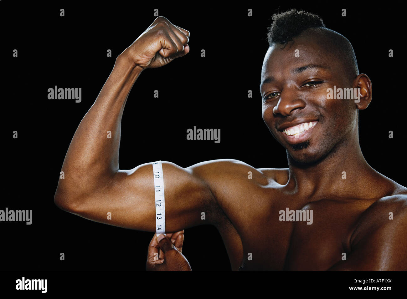https://c8.alamy.com/comp/A7F1XX/african-man-measuring-flexed-biceps-A7F1XX.jpg