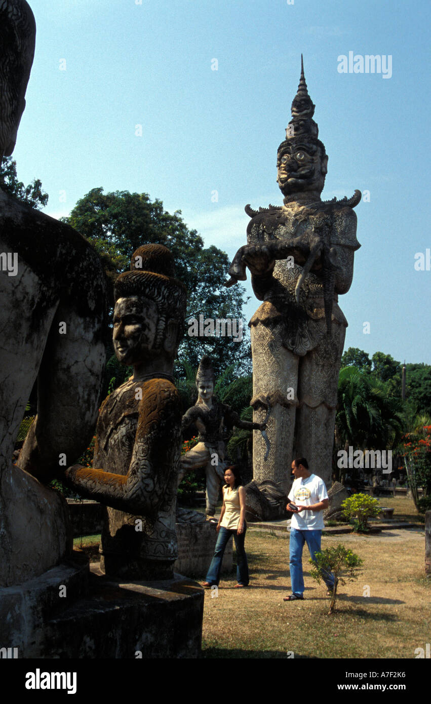 Local Tourists walking between sculptures, Wat Xieng Khuan Buddha Sculpture Park, Laos Stock Photo