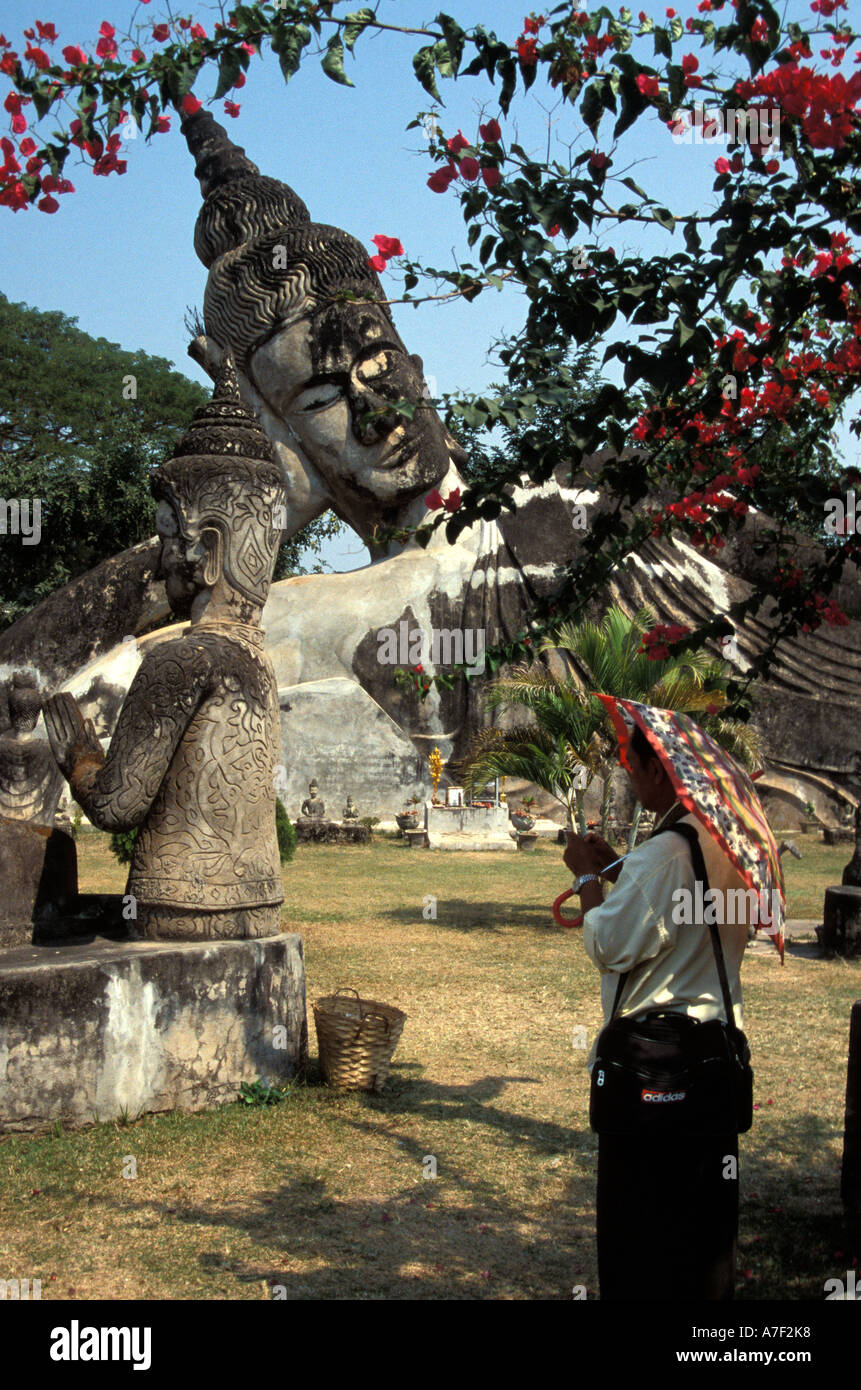 Local Tourist admires sculpture at Wat Xieng Khuan Buddha Sculpture Park, Laos Stock Photo