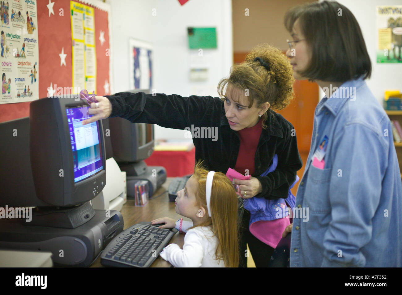 Pre kindergarten Teacher With Four Year Old Girl Learning Computer ...