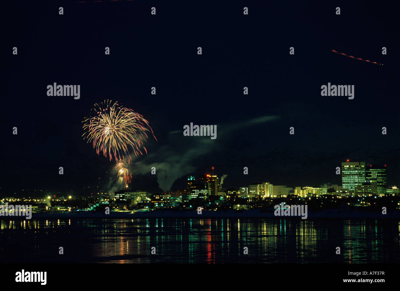USA Alaska Winter fireworks display over Anchorage skyline during