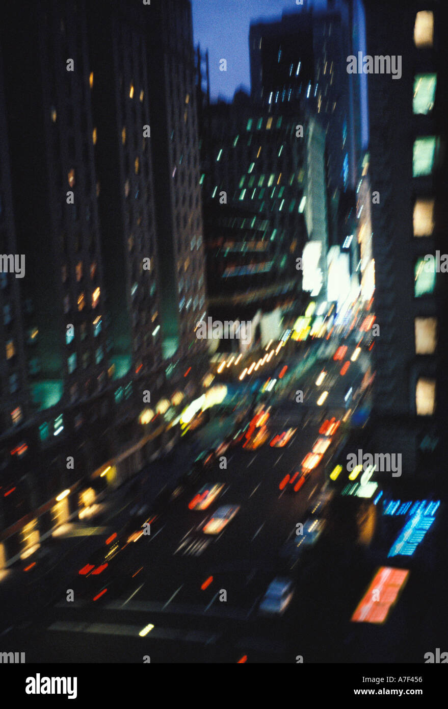 Busy New York City street scene at night with traffic motion blurred ...